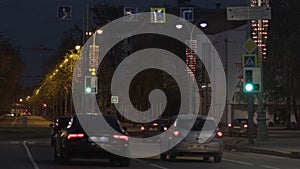 Night summer urban view of rare cars driving slowly on the road. Stock footage. Night traffic in the city, moving cars