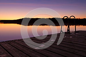 Night swim dock and calm lake at twilight