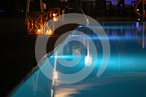 Night swimming pool and candles