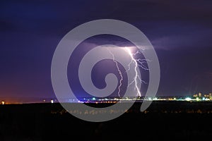 Night thunder lightning over the city sky