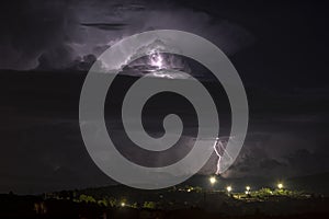 Night thunderstorm over the city, Sardinia, Italy photo