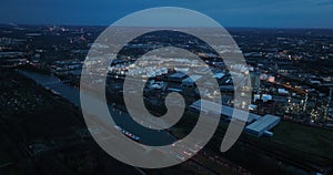 Night time aerial drone view of the industrial port of Gelschenkirchen, sluice and harbor. Industiral zone.