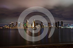 Night-time aerial view of a lake and a city skyline in the background, San Diego skyline