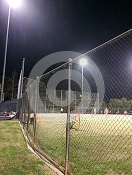 Night time baseball game at playing field outdoor