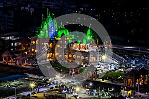 Night time green lighting on Shree Swaminarayan temple at night, Pune, India.