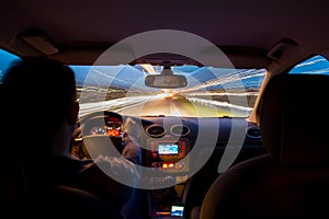 Night time highway from inside car with motion blurred speeding