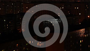 Night time lapse of Light in the windows of a multistory building. life in a big city