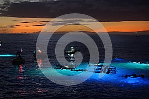 Night time manta ray snorkel and dive tour boats off the Kona Coast in Hawaii.