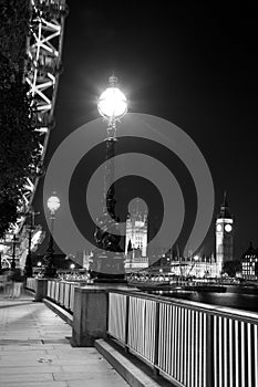 Night time monochrome portrait of the South Bank in London showing Big Ben and the Houses of Parliament