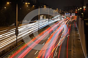 Night time photograph of speeding traffic driving along a highway in the city of Munich, Germany.