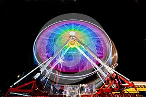 Night time rainbow colored ferris wheel