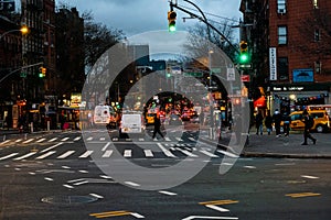 Night time scene in New York City showing cars driving in busy Manhattan.