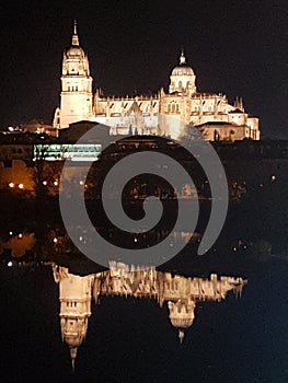 Night time view of Salamanca with reflection in river