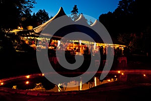 Night time wedding tent with a pool reflection photo