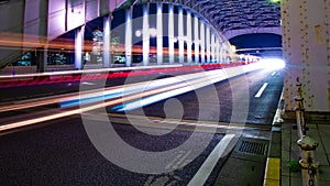 A night timelapse of the city street near Kachidoki bridge in Tokyo wide shot panning