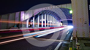 A night timelapse of the city street near Kachidoki bridge in Tokyo wide shot tilt