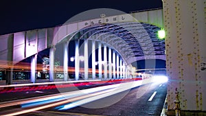 A night timelapse of the city street near Kachidoki bridge in Tokyo wide shot zoom