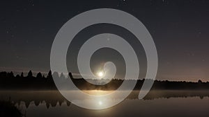 Night Timelapse with the Moon and Stars above a Lake