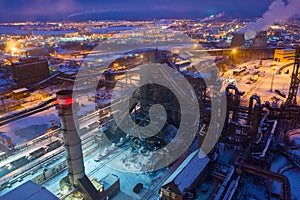 Night top view of a steel mill. Smog, smoke and flame from the chimneys