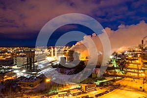Night top view of a steel mill. Smog, smoke and flame from chimneys