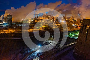 Night top view of a steel mill. Smog, smoke and flame from the chimneys