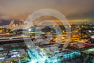 Night top view of a steel mill. Smog, smoke and flame from the chimneys. Industrial zone