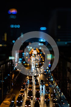 Night traffic in Bangkok. Street in the city center filled with cars passenger buses bikes and taxis. Night city lights up