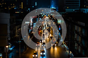 Night traffic in Bangkok. Street in the city center filled with cars passenger buses bikes and taxis. Night city lights up