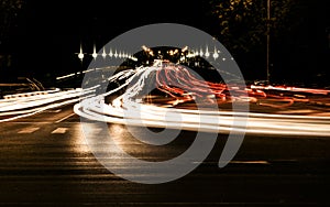 Night traffic in the city and blurry lights from headlights of cars