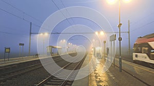 Night train in the fog. Station in fog and darkness. Passage of express train in fog and darkness. Concept of transport