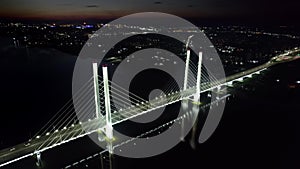 Night urban illuminated bridge street avenue crossing river sea traffic transportation aerial view