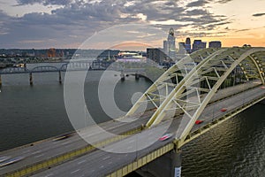 Night urban landscape of downtown district of Cincinnati city in Ohio, USA. Skyline with driving cars on bridge and