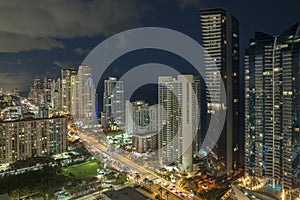 Night urban landscape of downtown district in Sunny Isles Beach city in Florida, USA. Skyline with brightly illuminated