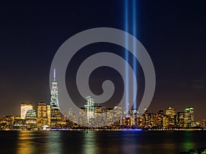 Night view of the 911 memorial light and the New York City skyline