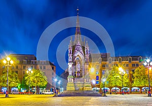 Night view of the Albert memorial on Albert square in front of the town hall in Manchester, England