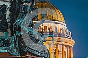 Night view of the ancient statues of stucco and the dome of St. Isaac`s Cathedral Saint-Petersburg. photo