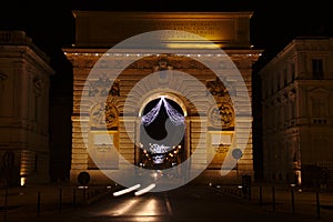 Night view of the Arc de triomphe in Montpellier, France