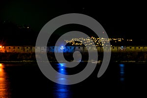 Night view of bay seawall backlights and far lights of the coast