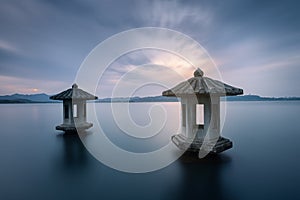 Night view of the beautiful landscape in West Lake in Hangzhou, with two stone lanterns in the lake