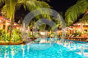Night view of beautiful swimming pool in tropical resort