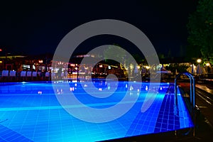 Night view of beautiful swimming pool in tropical resort