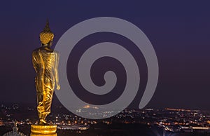 Night view of big public big golden buddha statue standing in Wat Phra That Kao Noi at Nan province Thailand