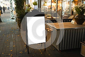 Night view of a blank billboard in front of the restaurant-cafe