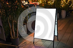 Night view of a blank billboard in front of the restaurant-cafe