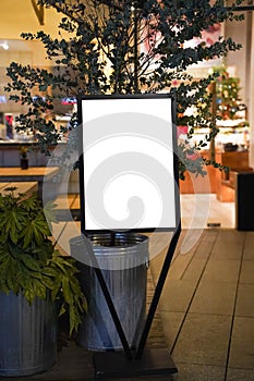 Night view of a blank billboard in front of the restaurant-cafe