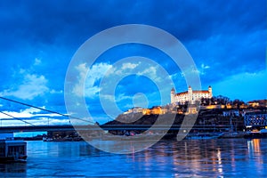 Night view of Bratislava castle from river surface with dramtic sunset skyline