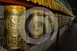 Night view of buddhist tibetian prayer wheels. Potala Palace in Lhasa, Tibet, China