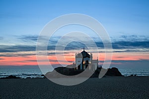 Night view of Chapel Senhor da Pedra at Miramar Beach, near Porto photo