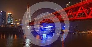 Night view of Chongqing city.  View of the bridge over the river.  Lighting and office buildings.  River reflections and lights.