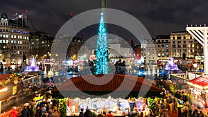 London, UK/Europe; 20/12/2019: Night view of Christmas market, Christmas tree and menorah in Trafalgar Square in London. Long